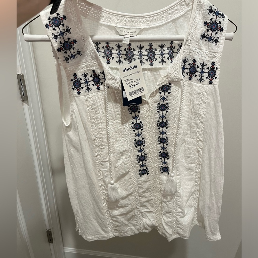 White top with some blue detail